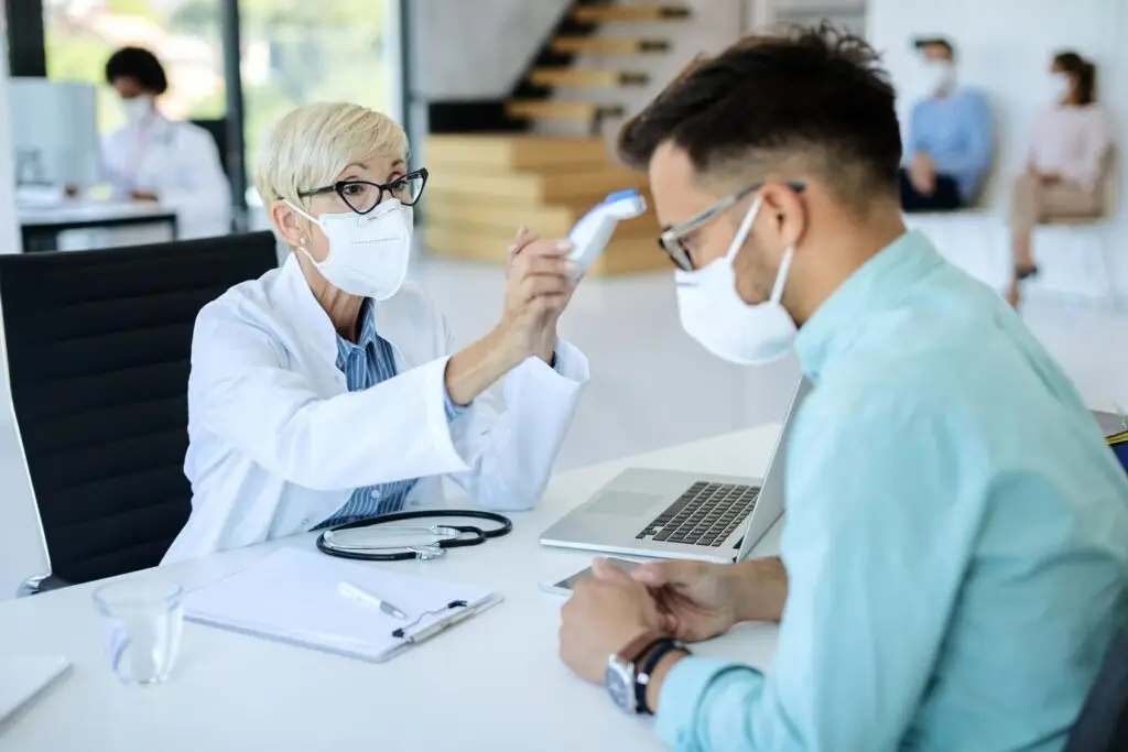 doctor measuring body temperature