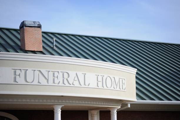 Close up of funeral home sign engraved on curved building front with copy space above
